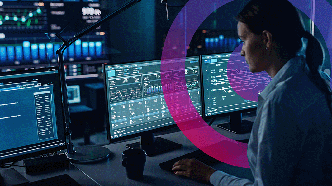 Woman looking at computer screen analysing data and dashboards.