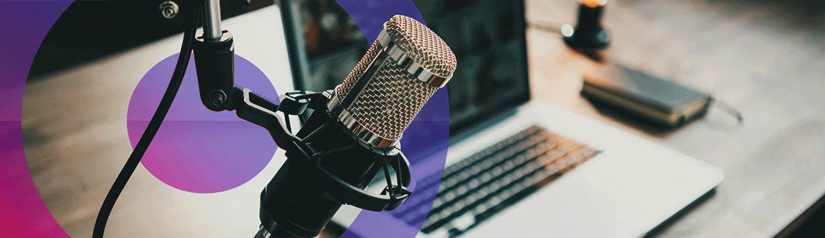 Podcast set up with microphone and laptop in a studio.
