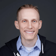 Picture of man smiling wearing a blue shirt 