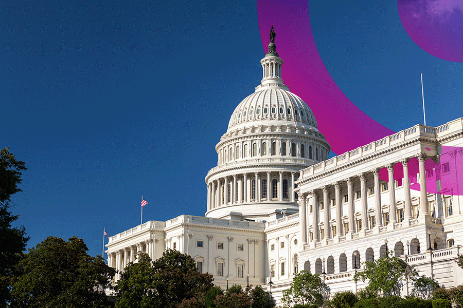 Large white government building with dome in Washington USA. There are trees in front of the building and US flag posts on the buildings roof. blue and pink cora lens in the top right corner of the image.