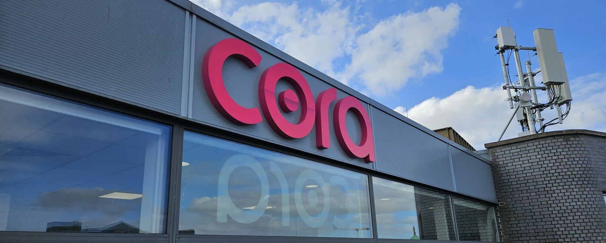 Image of pink Cora logo on a building in Dublin