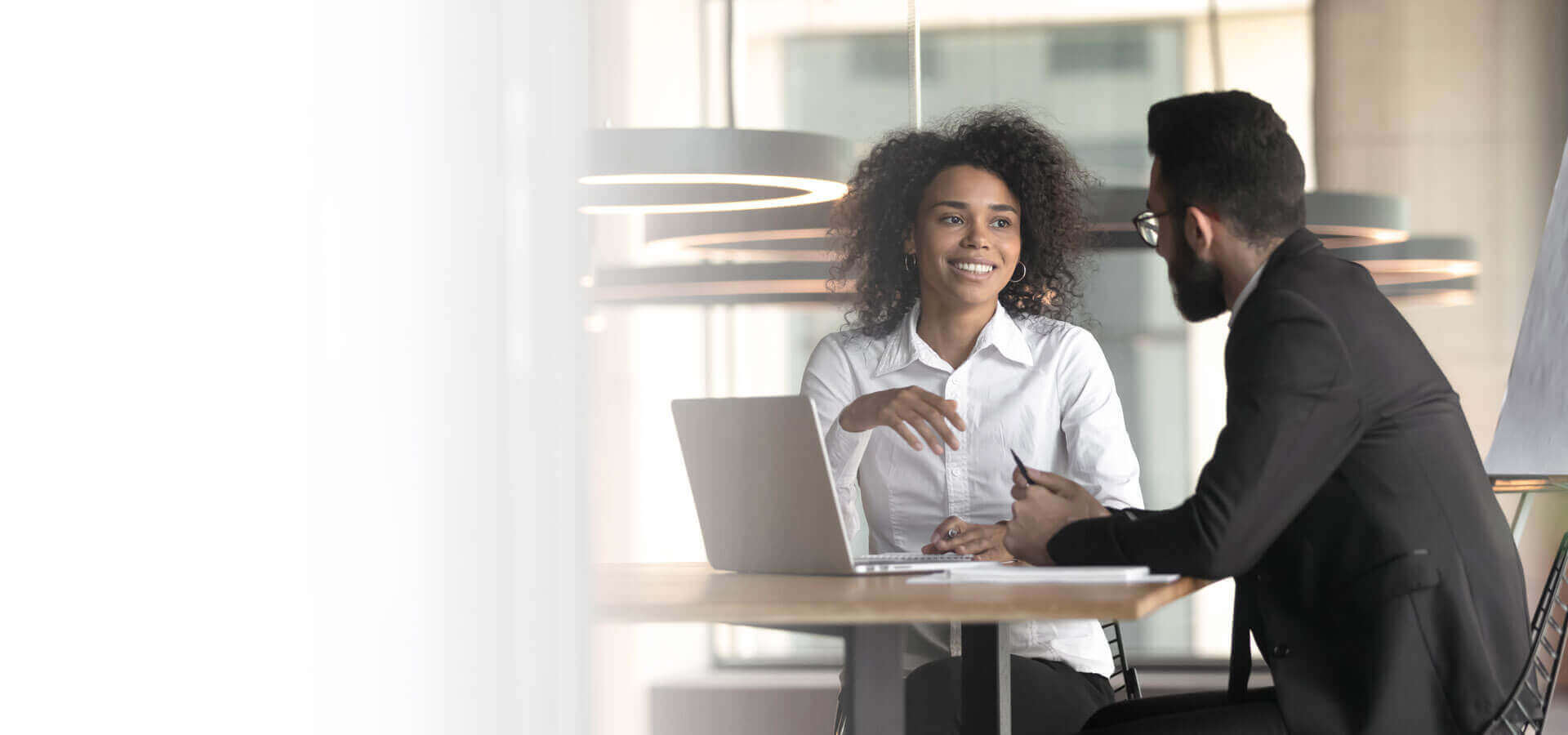 Two people having a meeting in an office.