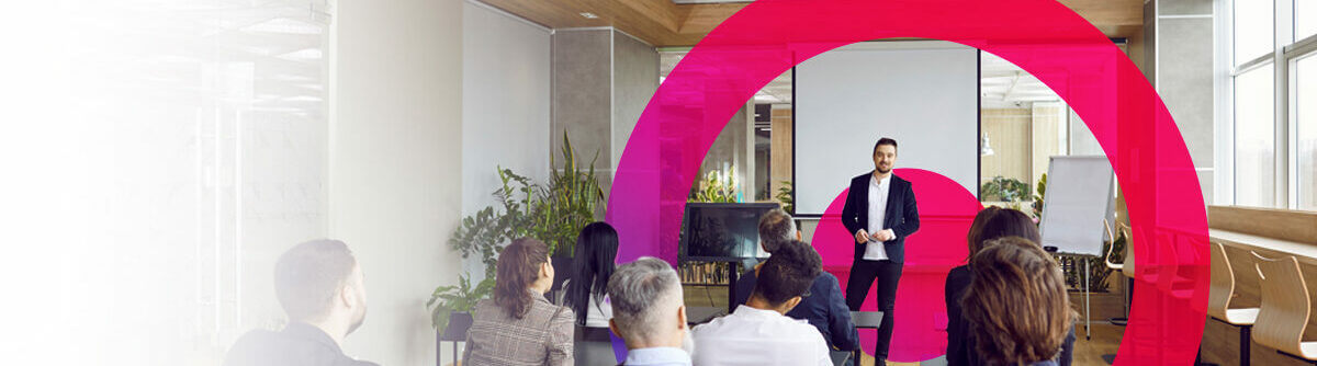 A man is conducting a meeting with his team in an office.