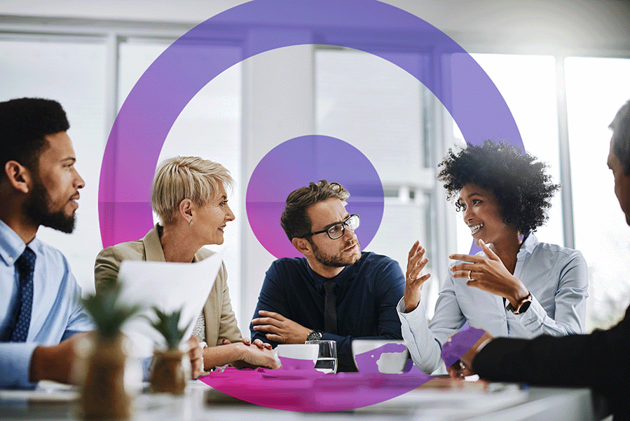 Finance Team of 5 people meeting in an office discussing work.