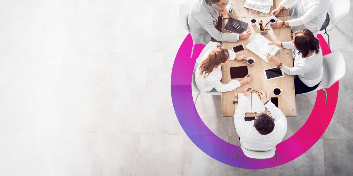 A team of people having a meeting around a table discussing. Pink and purple gradient lens graphic in the background.