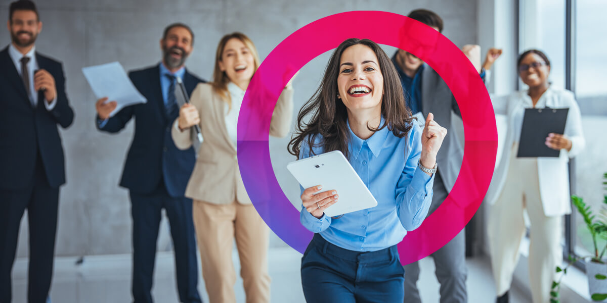 Woman and team cheering in an office with a pink and purple lens logo around the middle.